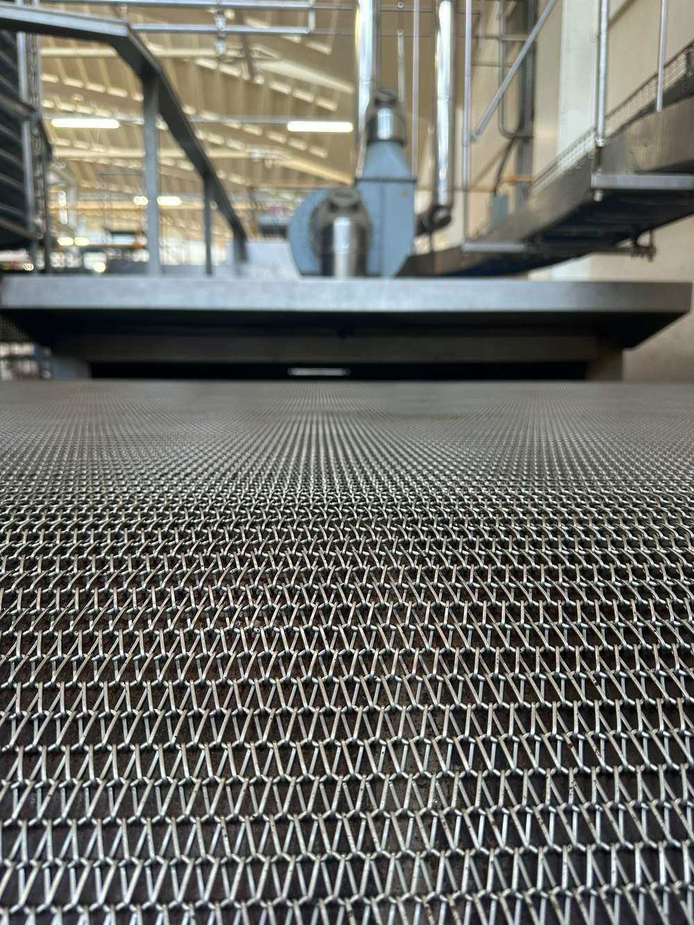 Close up of the newly installed woven wire oven band