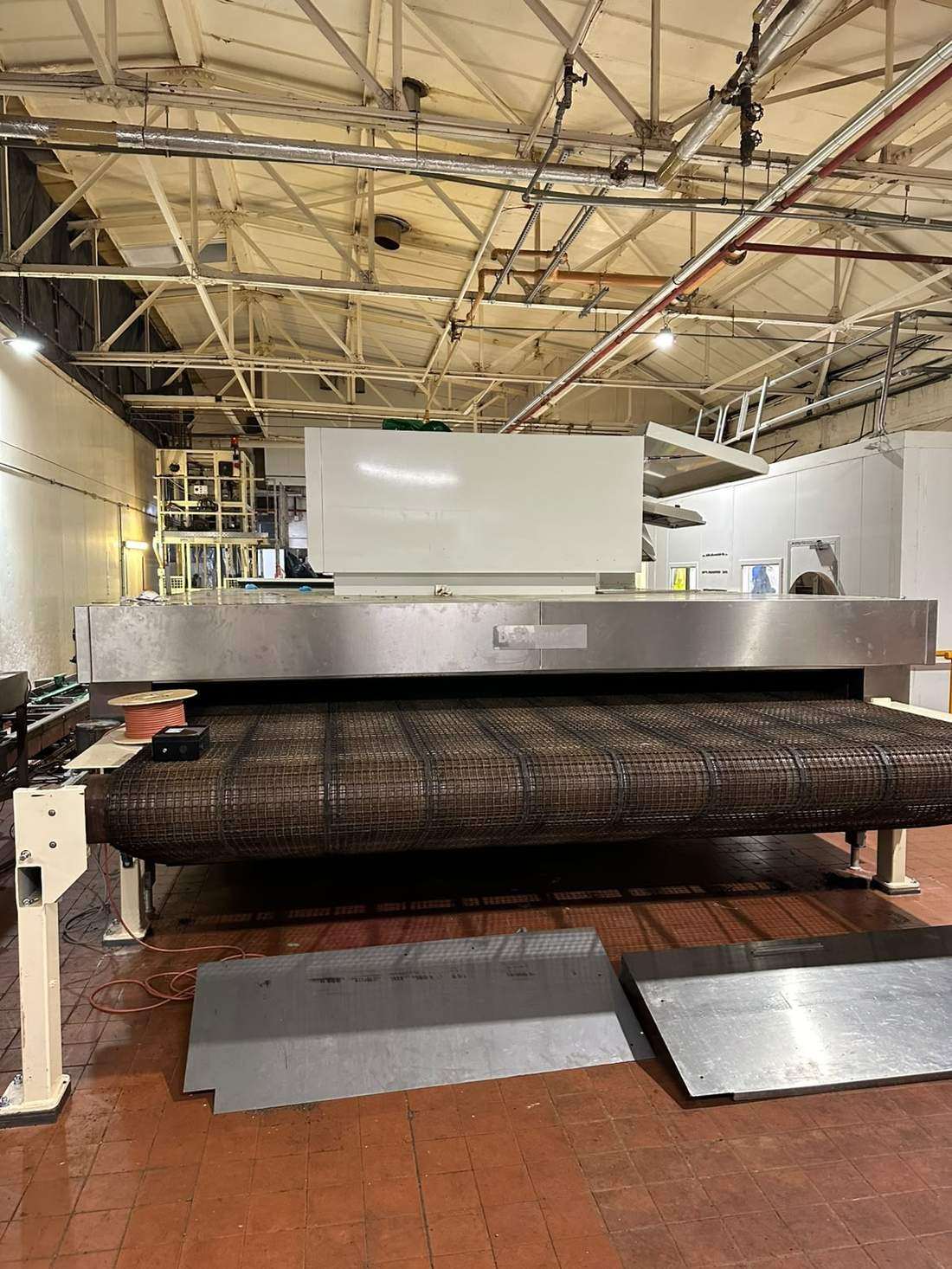 New oven band rolled up at the oven mouth ready for feeding through