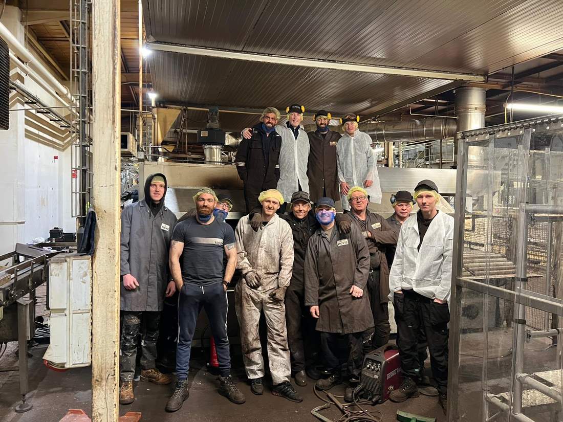 The full installation team in front of the completed oven