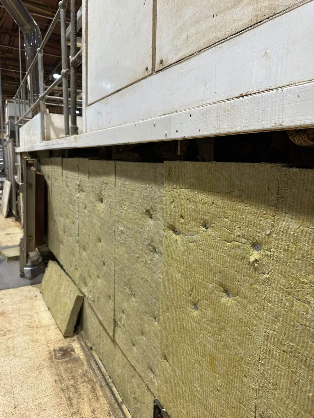 New mineral wool insulation pinned to the oven side